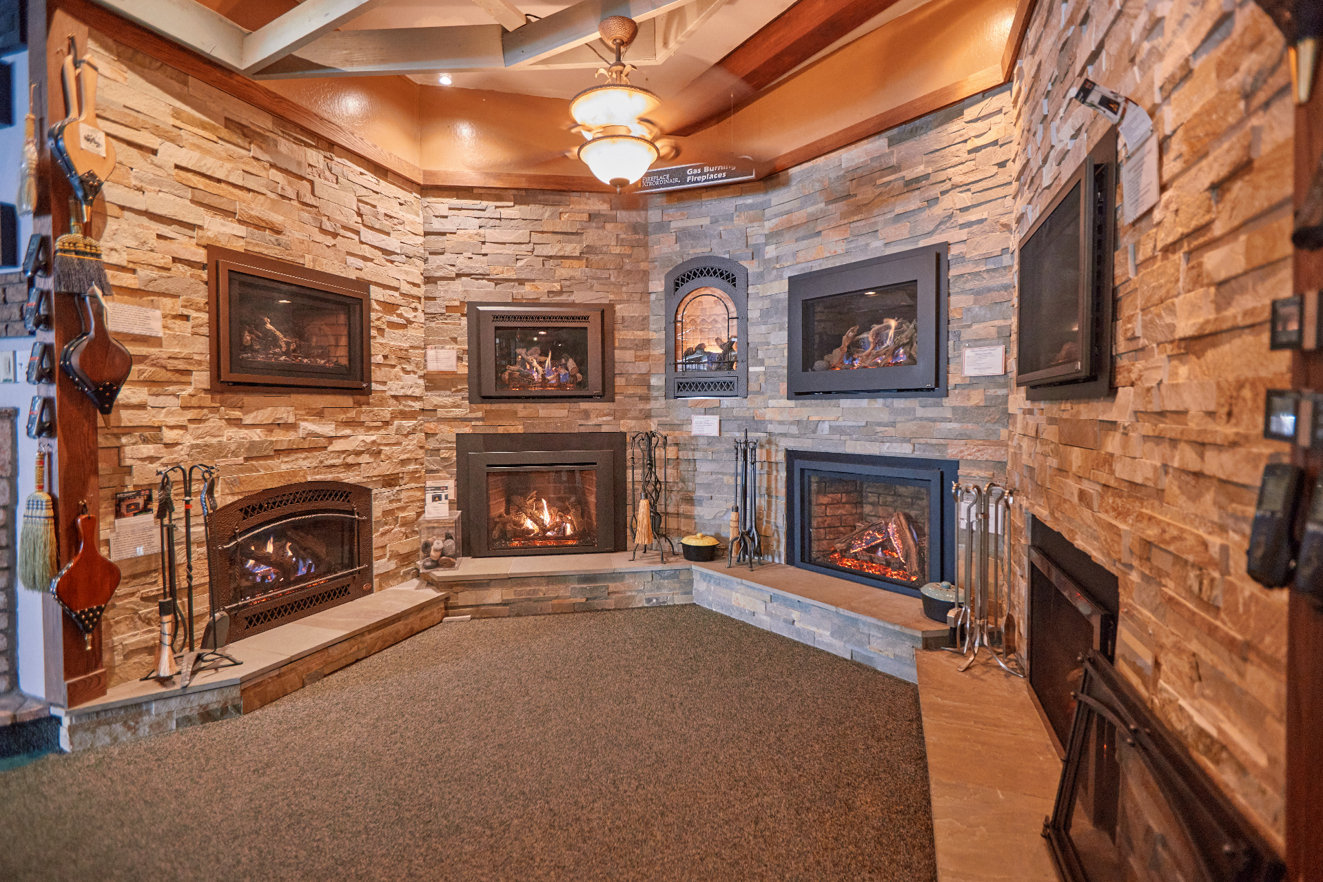 Buck Stove showroom with fireplaces and ceiling fans